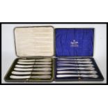 Two cased sets of silver handled butter knives to include a set of six Harrison Fisher & Co silver