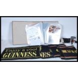 Guinness Breweriana. Box with album of vintage and more modern advertising postcards, beer mats, bar