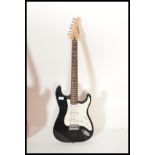 A vintage Marlin electric stratocaster style six string electric guitar having a black body with