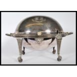 A silver plate muffin warmer raised on four legs with claw and ball feet, with gadrooned