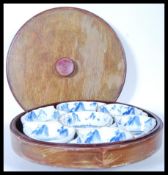A 20th Century Chinese lazy Susan consisting of a round lidded wooden box with rotating base below
