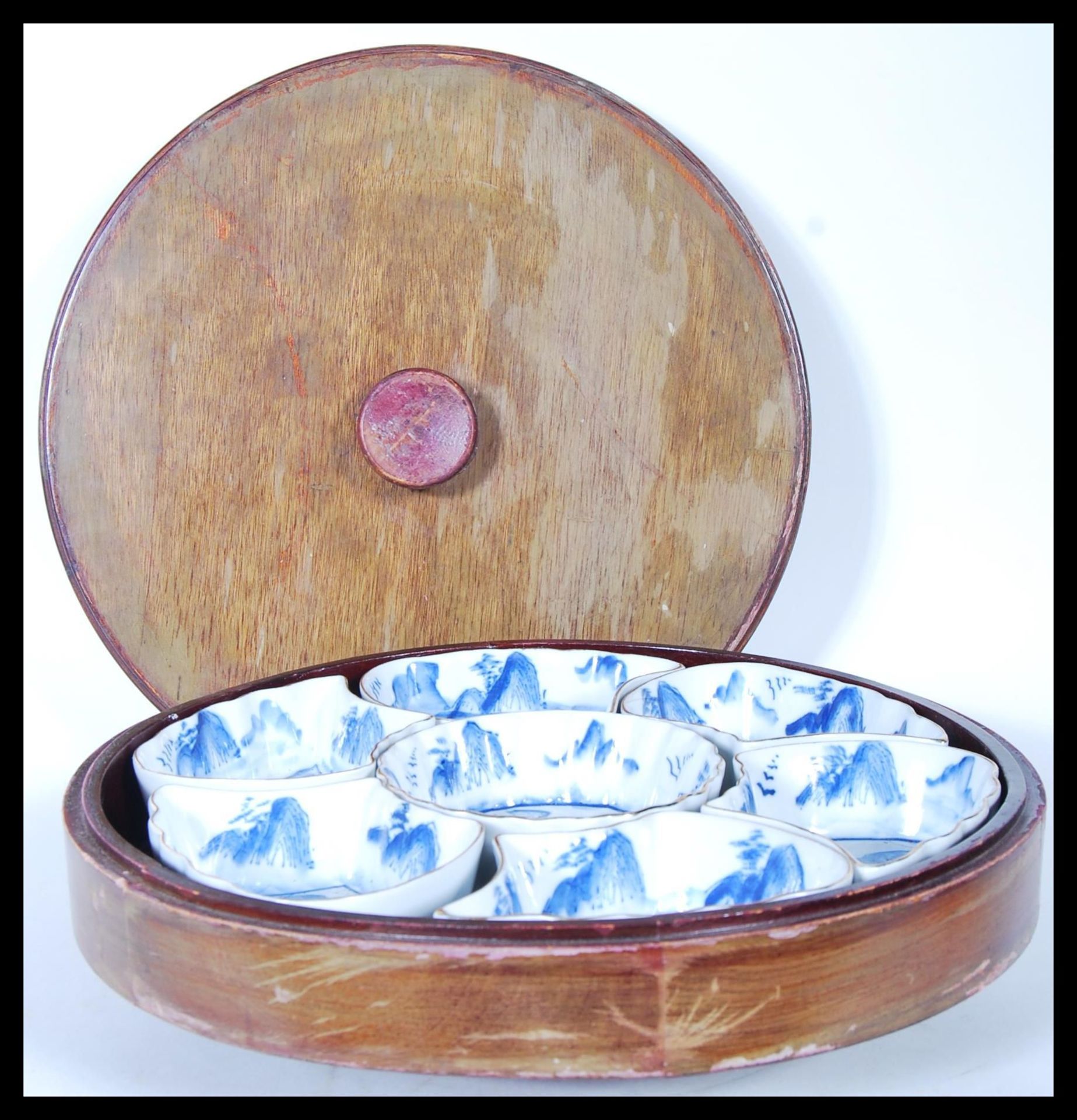 A 20th Century Chinese lazy Susan consisting of a round lidded wooden box with rotating base below