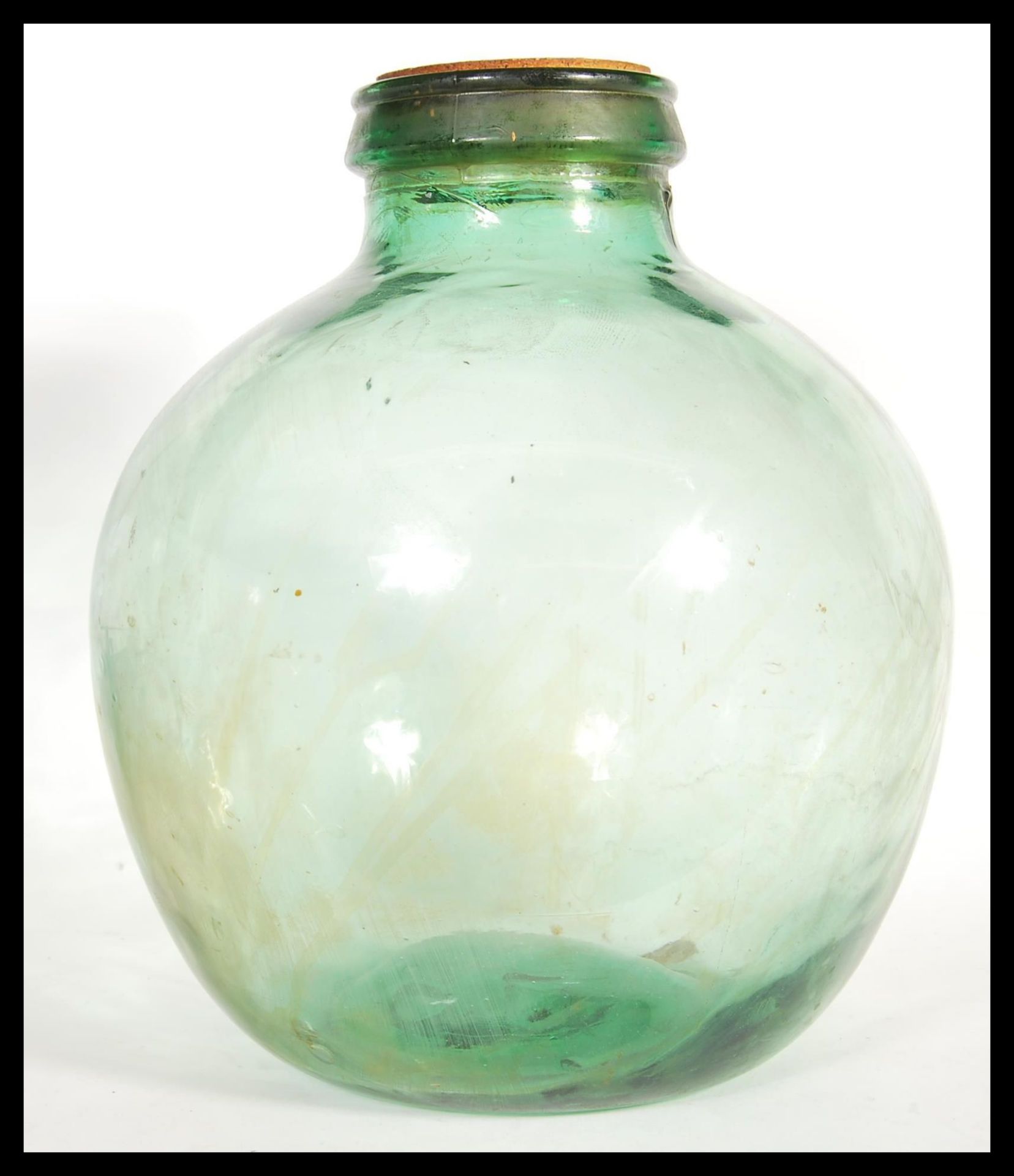 A vintage 20th century large bluish green glass carbouy of bulbous form.