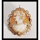 A 9ct gold / 375 marked ladies cameo brooch depicting a maiden facing left, pin verso with