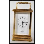 A 20th Century St James of London gilt brass carriage clock, the enamel dial with Roman numerals, on