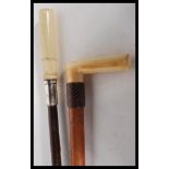 Two Victorian 19th Century walking stick cane tops. Both having ivory handles, one with leather band