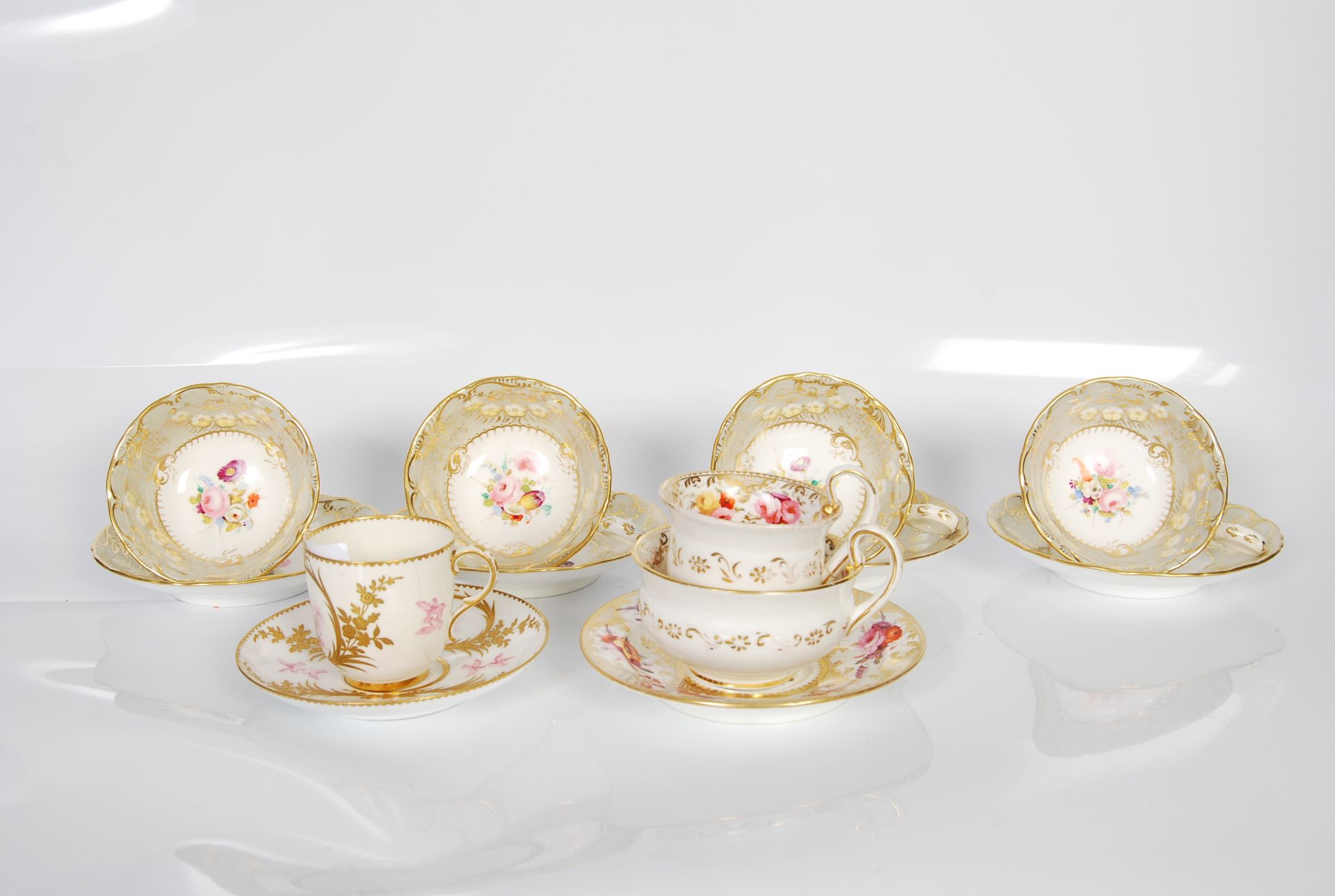 A set of four 19th/20th Century Davenport hand painted cabinet cups and saucers, together with a