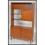 A retro 20th Century teak wood Danish inspired room divider bookcase having an arrangement of