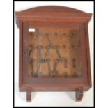 A late 19th/ early 20th Century oak wall hanging display cabinet, having single glazed door and