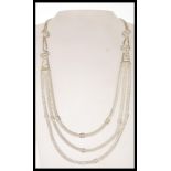 A 20th Century ethnic style silver necklace having three graduating snake chains with engraved