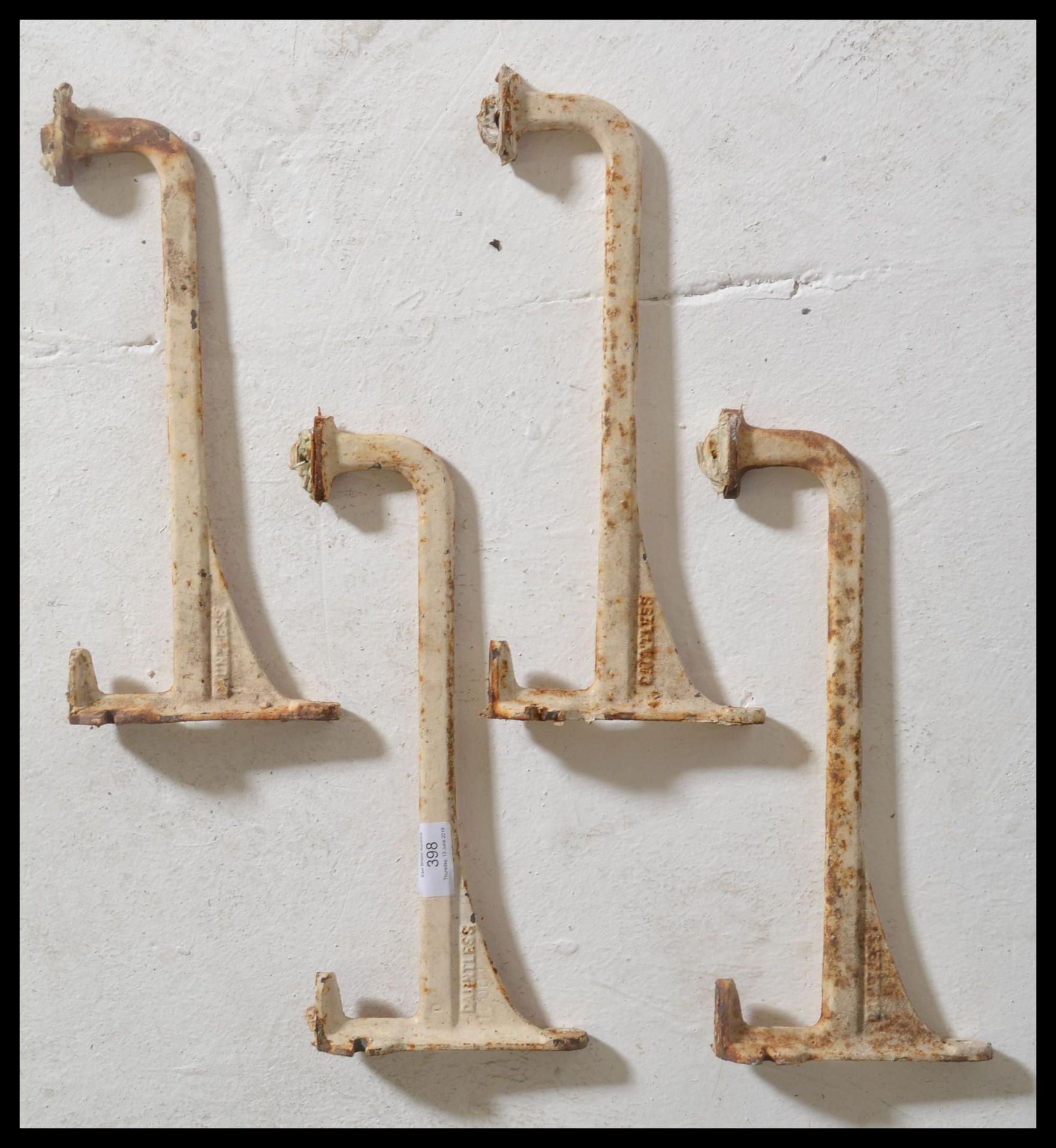 Architectural salvage - A group of four / two pairs cast iron wall shelving brackets, cast in relief