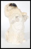 A 20th Century Beswick ceramic figure of a begging Pekingese dog with hand painted details.