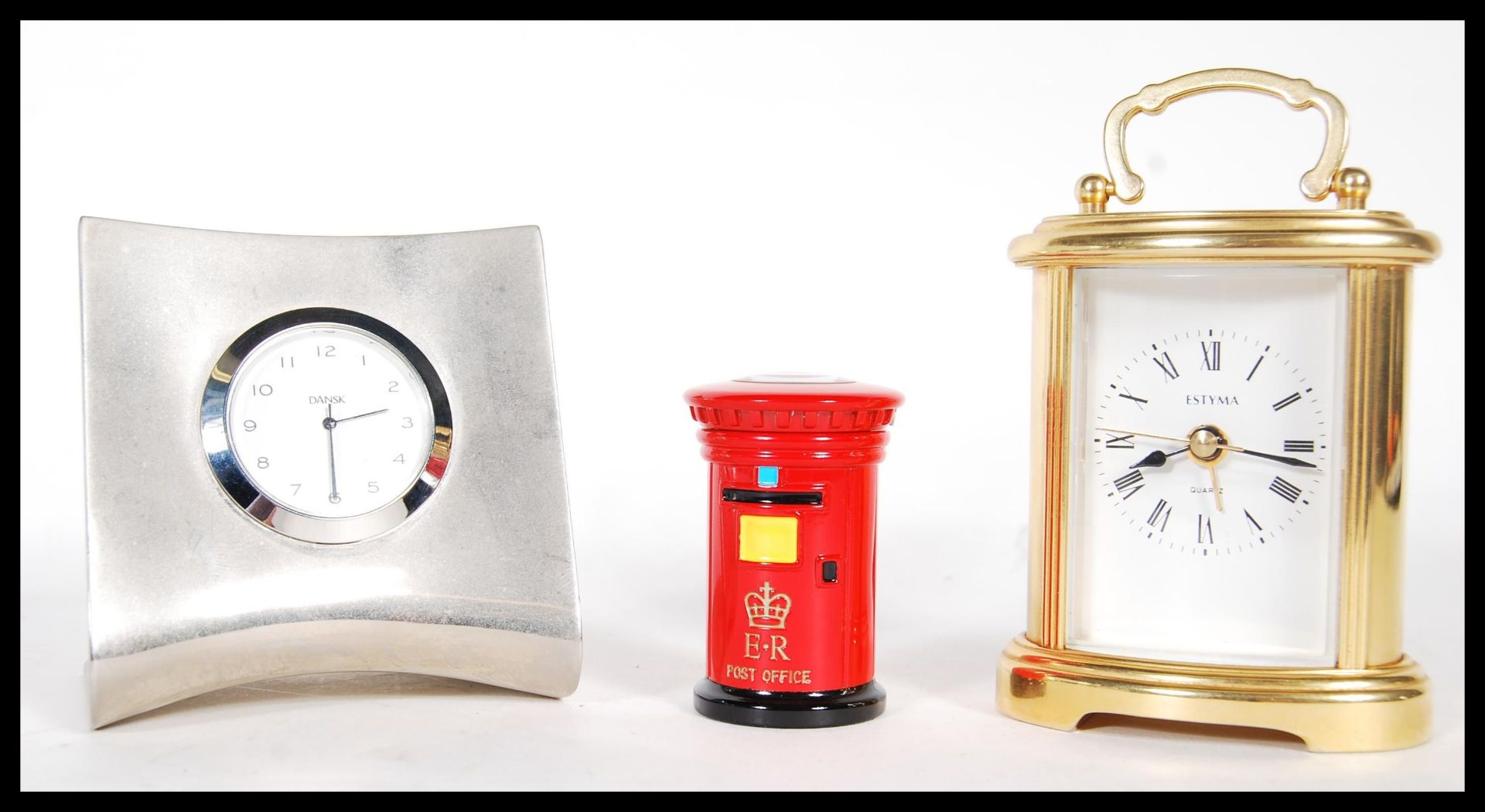 A group of three desk clocks to include a polished aluminium example by Dansk, together with a