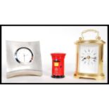 A group of three desk clocks to include a polished aluminium example by Dansk, together with a