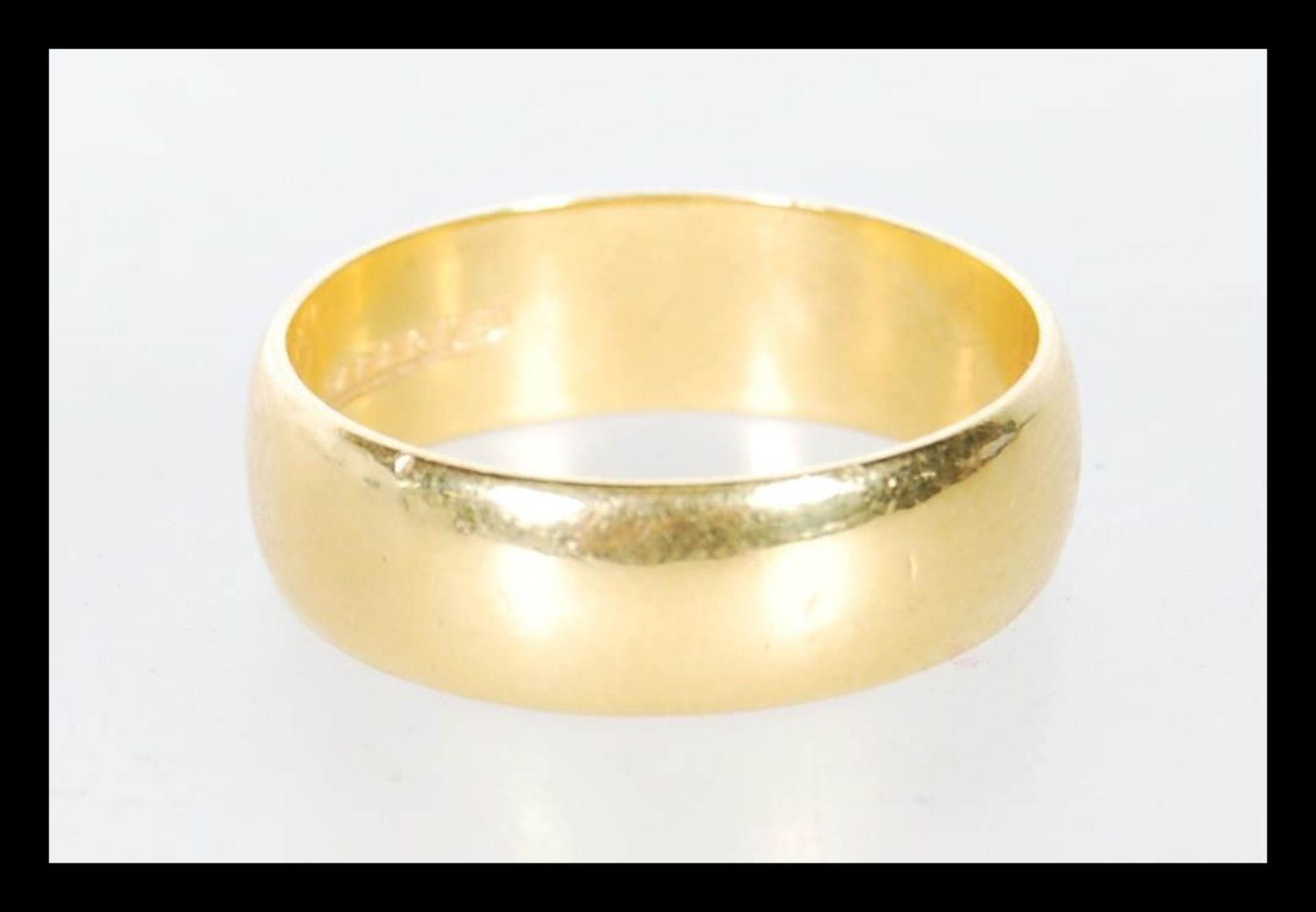 A hallmarked 22ct gold wedding band ring of typical form. Hallmarked Birmingham 1961. Weight 6.1g.