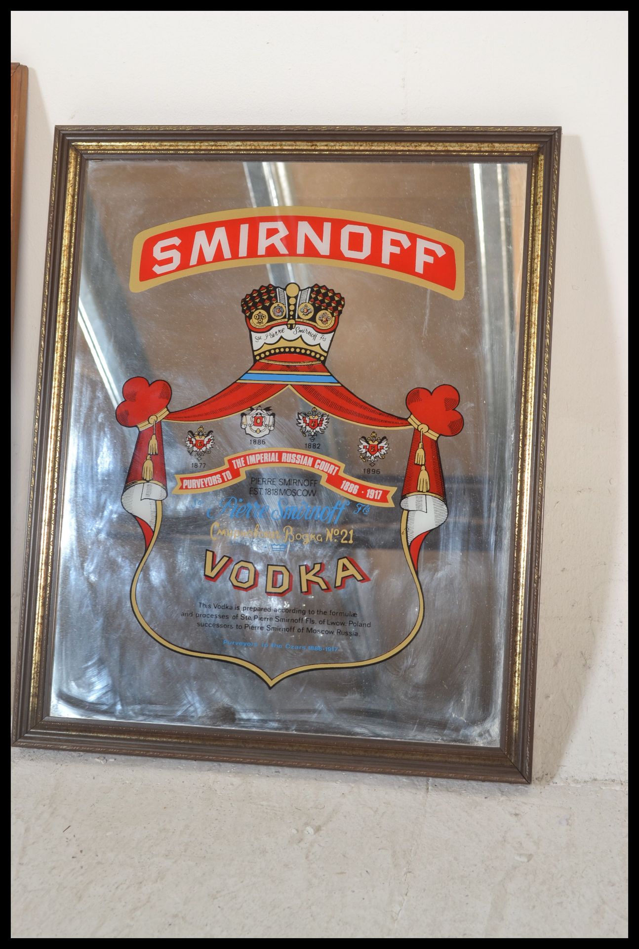 Two 20th Century pub advertising mirrors, one being for Martini Vermouth vino set within a pine