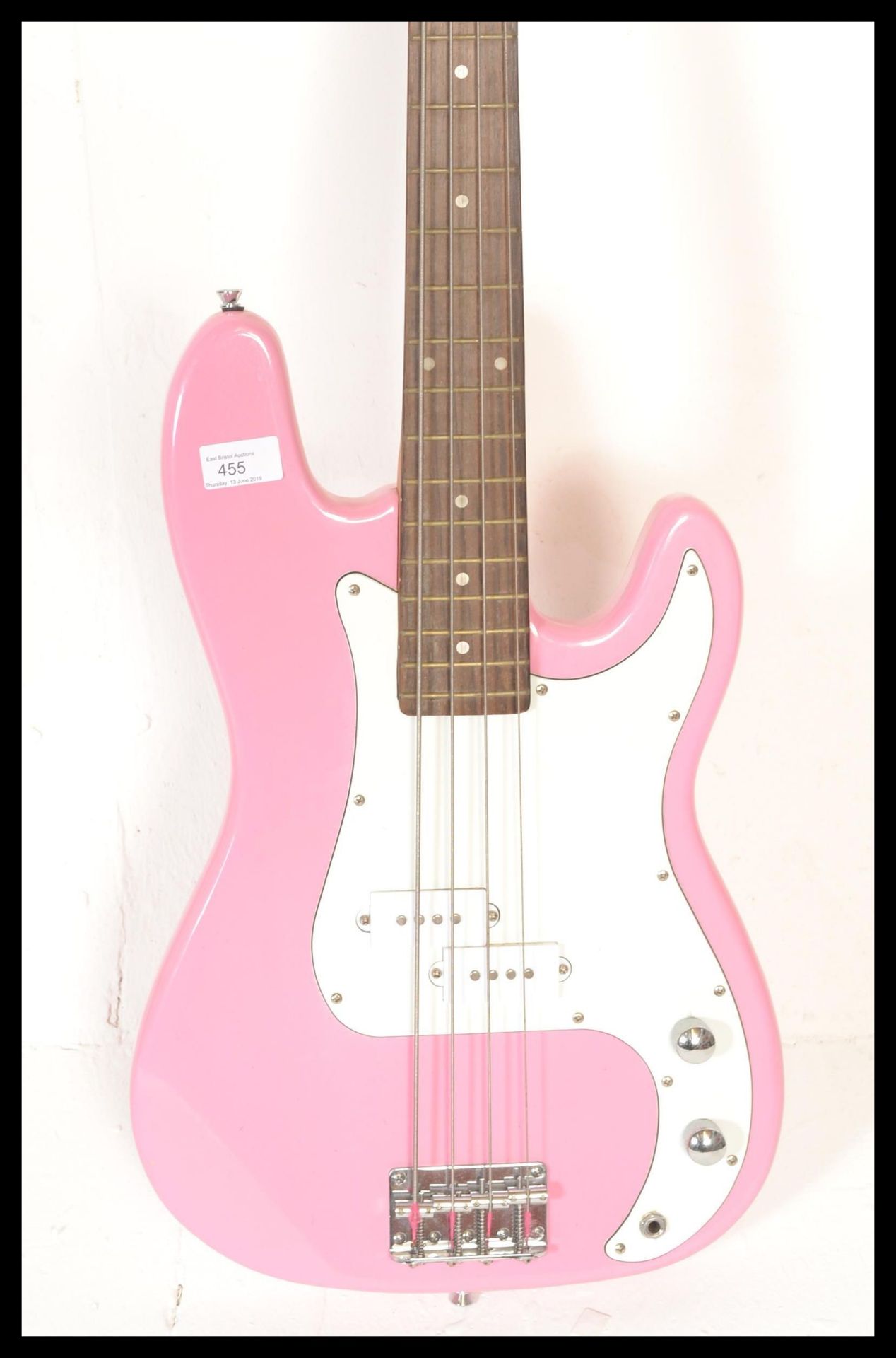 A four string electric bass guitar by swift having a hot pink sprayed body with white scratch guard. - Bild 3 aus 4