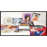 A collection of Elvis Presley music memorabilia to include pendants, fridge magnets, plates, key