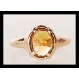 An 20th Century hallmarked 9ct gold ring set with a faceted orange stone. Hallmarked Chester 1912.