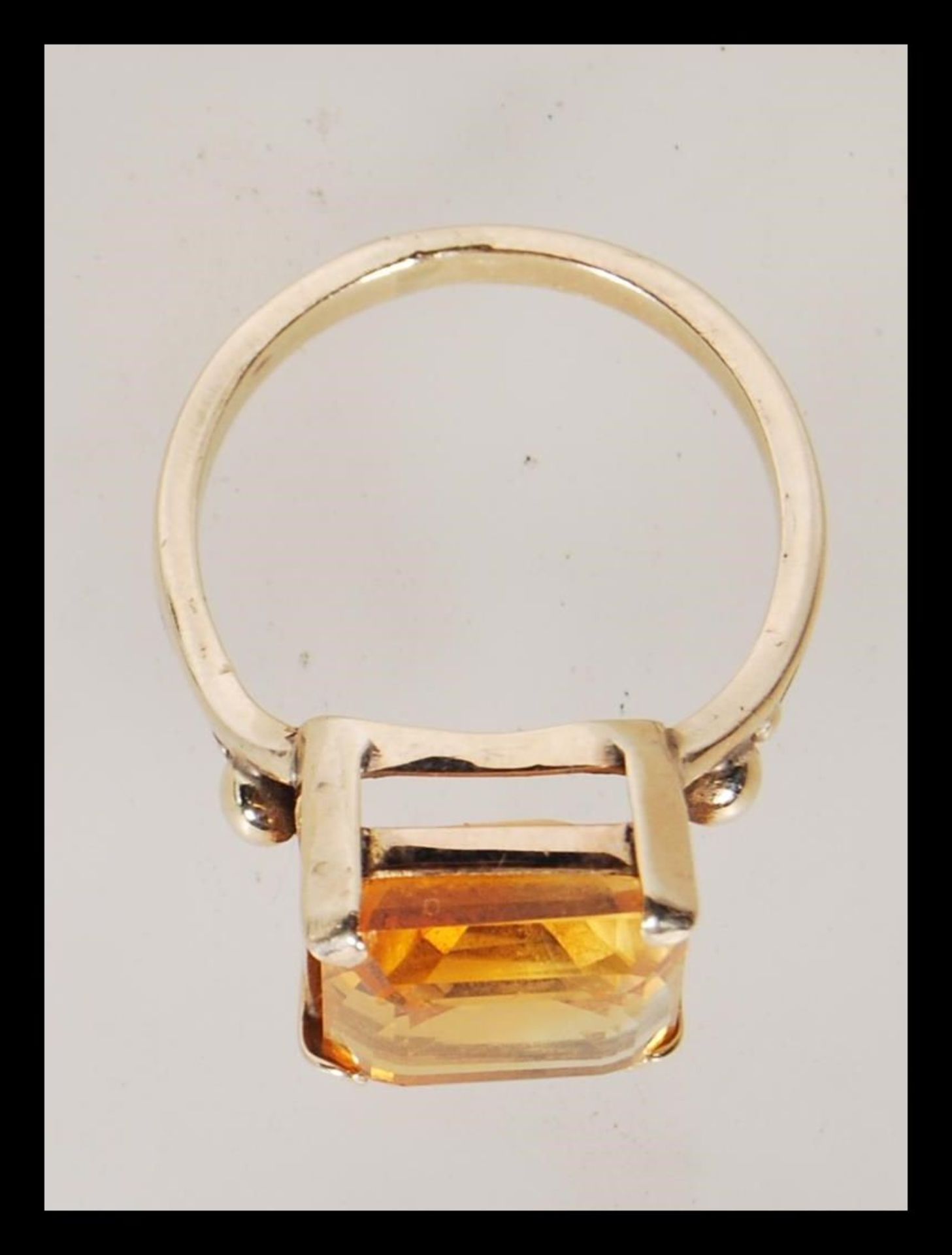 A 9ct gold dress ring, prong set with a square cut orange stone on a split shank mount. Unmarked but - Bild 4 aus 4