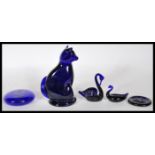 A collection of Bristol Blue glass items to include a cat figurine with a curled tail signed B