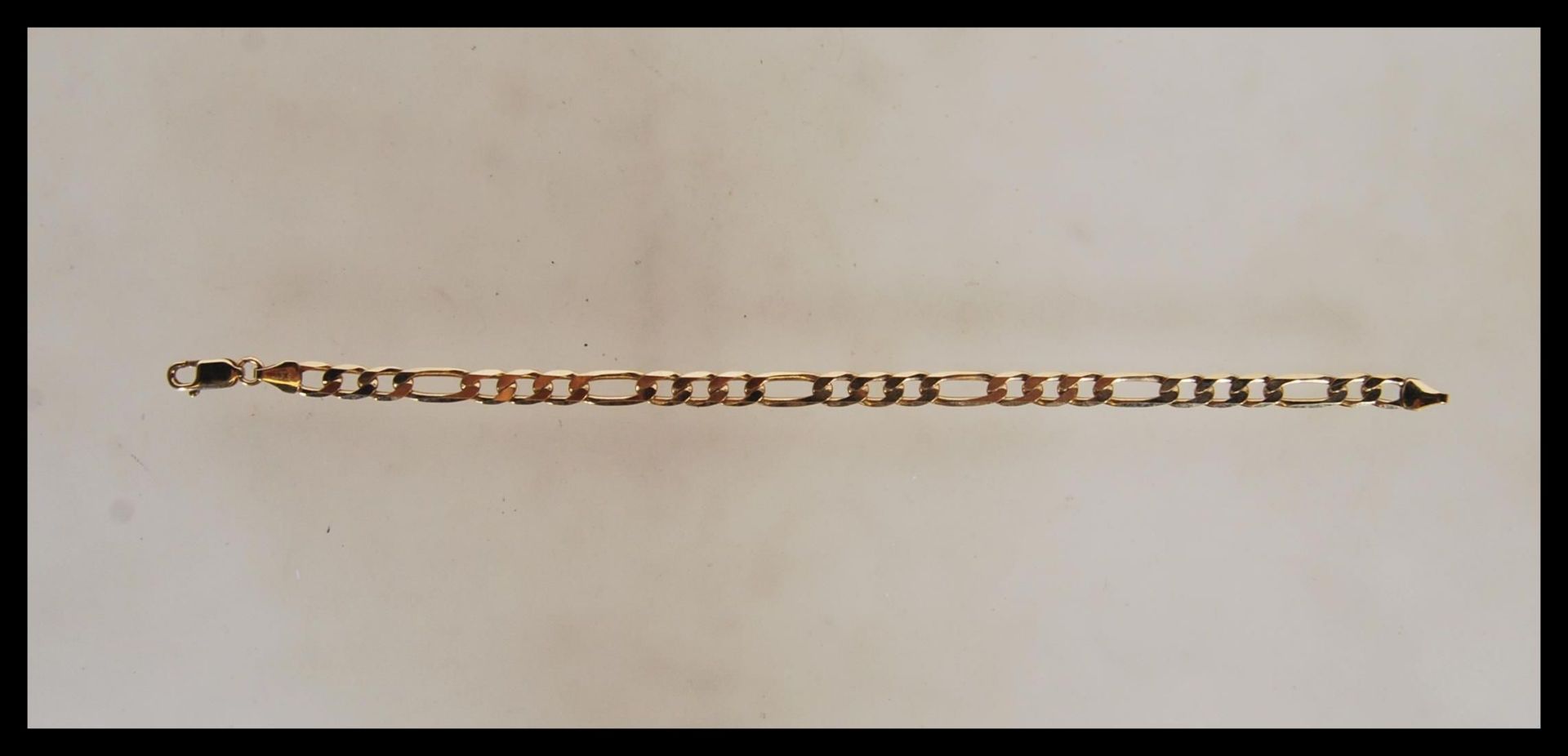 A 9ct gold triple link bracelet chain set with lobster clasp being stamped 375. Length 7" / Total