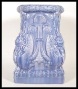 A 20th Century Art Nouveau ceramic Majolica plant stand finished in blue, having lions/ griffins