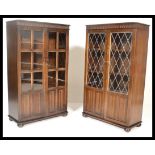 A pair of 20th century Priory oak cabinet. Each with chamfered edge tops over cabinets beneath