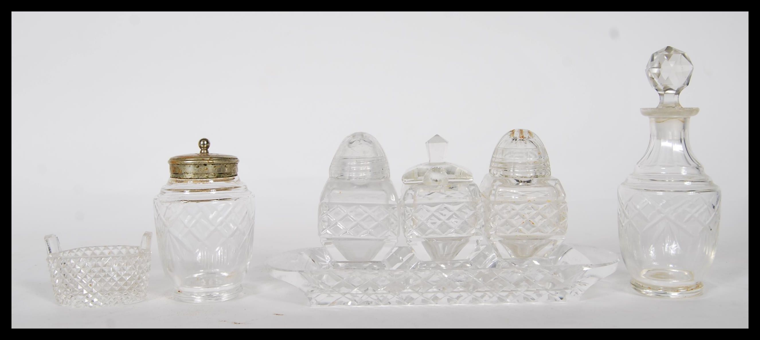 A collection of 20th Century cut glass cruets to include a three part cruet set consisting of