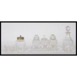 A collection of 20th Century cut glass cruets to include a three part cruet set consisting of