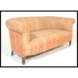 A late 19th / early 20th Century Chesterfield two seat sofa settee being upholstered in a period