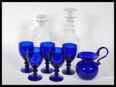 Five 20th Century Bristol Blue glasses together with a signed Bristol Blue jug of small proportion.