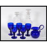 Five 20th Century Bristol Blue glasses together with a signed Bristol Blue jug of small proportion.