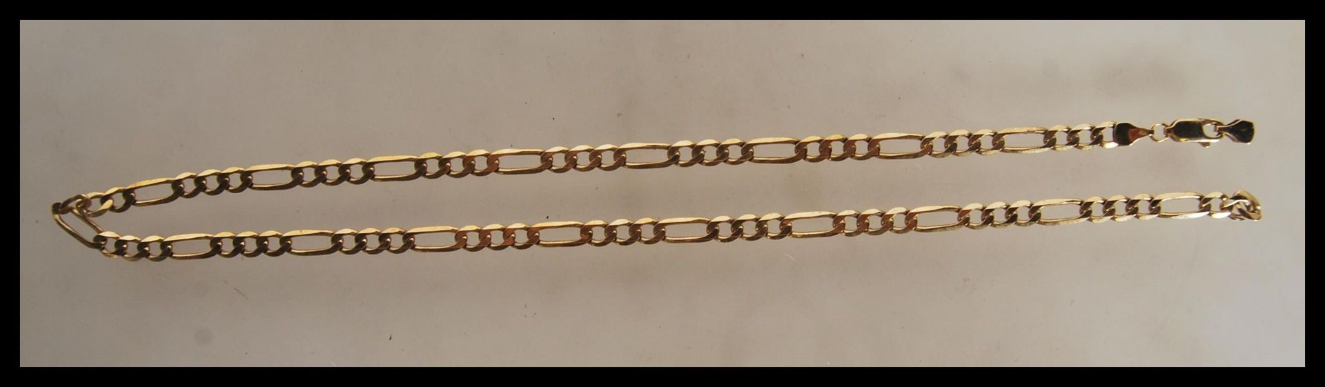 A 9ct gold triple link necklace chain set with lobster clasp being stamped 375. Length 17.5" /
