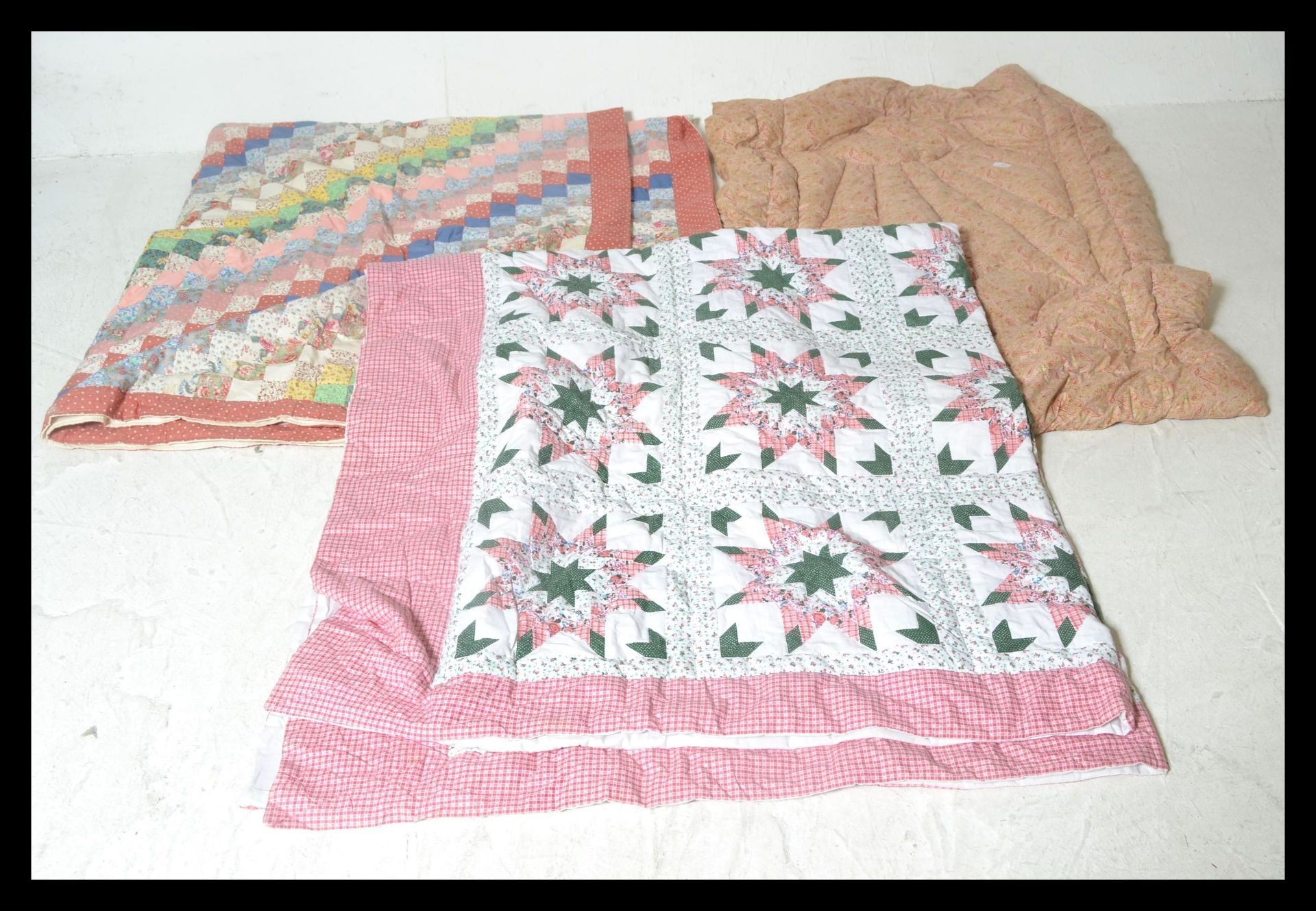 A collection of three vintage 20th Century quilts / bed throws to include an eider down filled quilt - Image 2 of 5