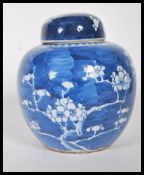 A 18th century Kangxi style Chinese blue and white Prunus pattern ginger jar and cover of ovoid form