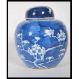 A 18th century Kangxi style Chinese blue and white Prunus pattern ginger jar and cover of ovoid form