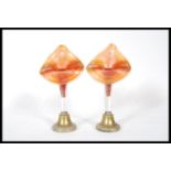 A pair of 19th Century Victorian spill vases having carnival glass orange luster spills with brass