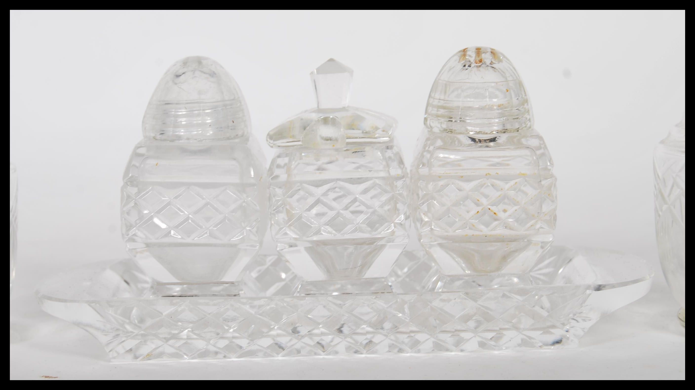 A collection of 20th Century cut glass cruets to include a three part cruet set consisting of - Image 4 of 6