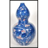 A large bulbous 20th Century Chinese blue and white double gourd vase in the Prunus pattern,