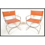 A pair or retro 20th Century chrome framed cantilever armchairs in the manner of Mart Stam, the seat