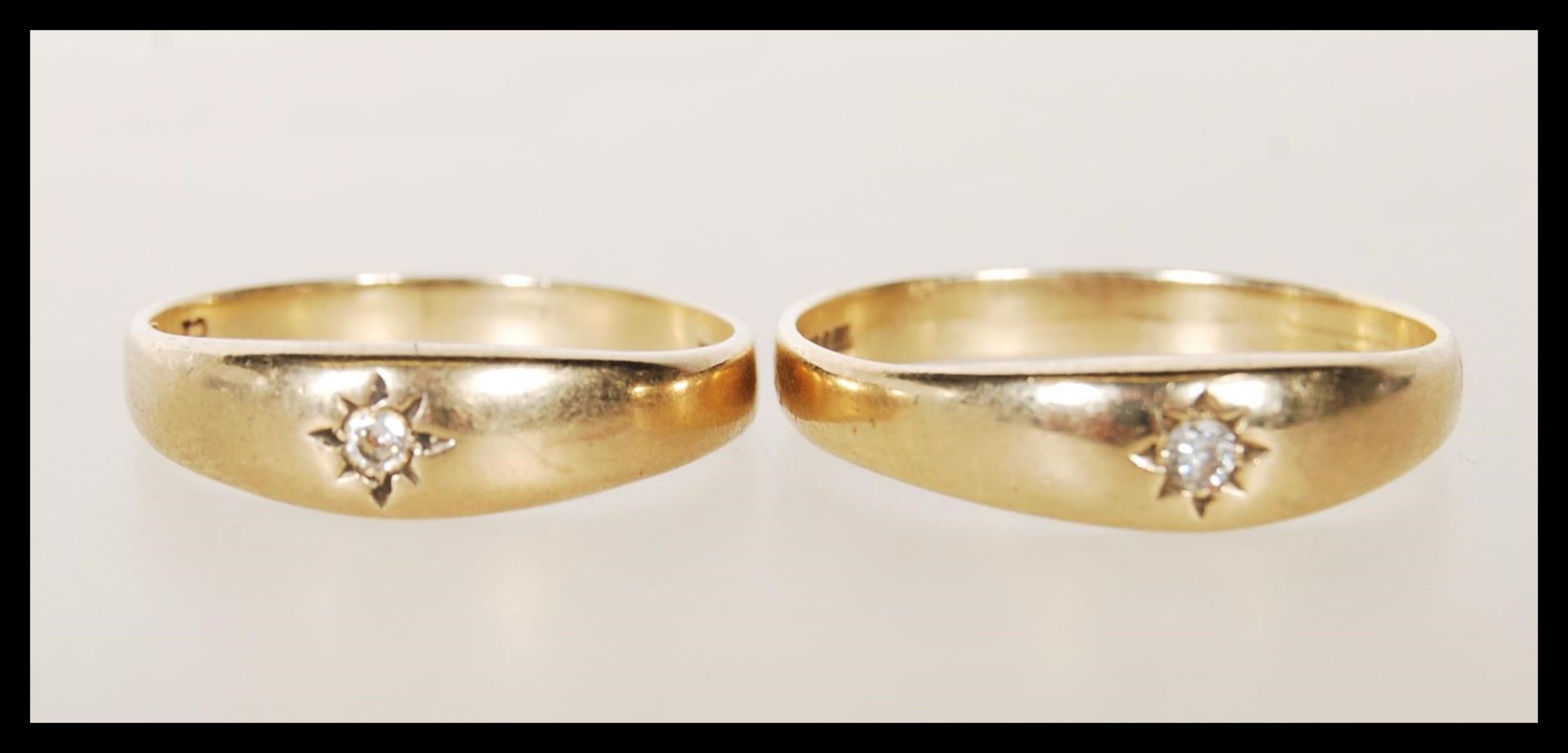 Two matching hallmarked 9ct gold rings both being gypsy set with cubic zirconia stones. Both