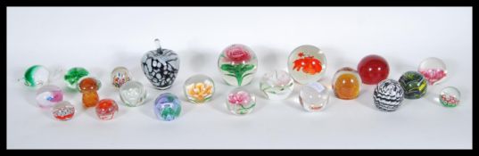 A collection of twenty one / 21 20th Century studio glass paperweights to include Caithness, control