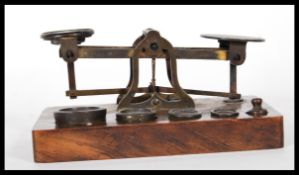 A set of 19th Century brass postal scales by S. Mordan & Co. London, on an oak base having five