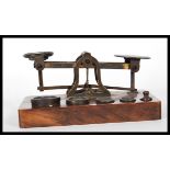 A set of 19th Century brass postal scales by S. Mordan & Co. London, on an oak base having five