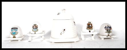 A collection of 4 crested ware beehive ( bee hive collectors interest ) to include Arcadian Derby,