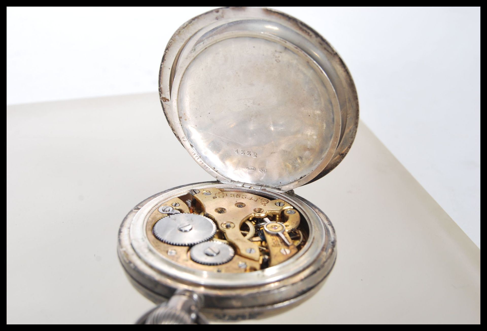 An early 20th Century silver pocket watch having a white enamelled face with roman numerals to the - Image 7 of 9
