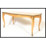 A 20th Century quarter panel Burr Walnut veneered coffee table of rectangular form, raised on French