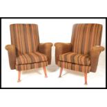 A pair of 20th Century vintage / retro fireside easy lounger armchairs being upholstered in wool