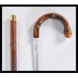 A 20th Century walking sword stick having crook handle with carved knob and brass band. handle pulls